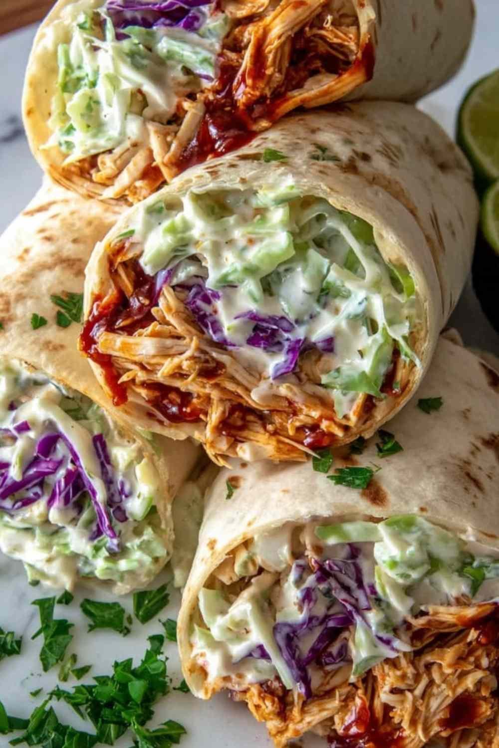bbq-chicken-coleslaw-wraps-cut-in-half-wooden-board